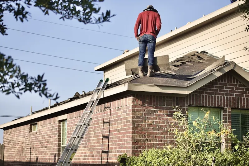 Professional roofer working on a residential roof in Meadows
